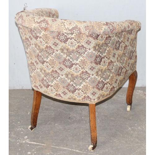 76 - A vintage upholstered tub chair with wooden legs and patterned upholstery, approx 61cm wide x 82cm t... 