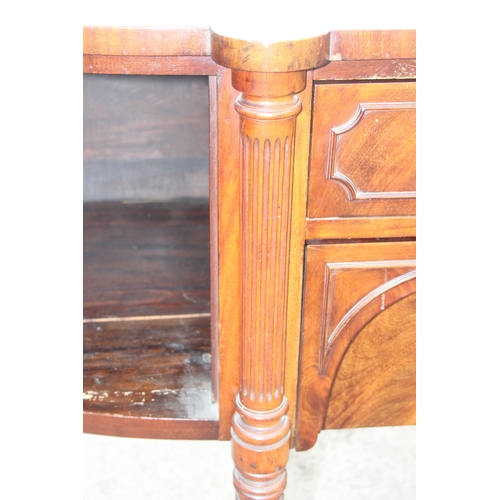 142 - A 19th century mahogany sideboard with 2 cupboards flanking 2 central drawers, approx 186cm W x 66cm... 