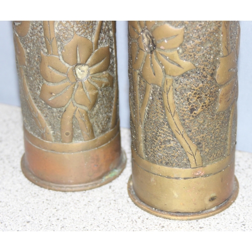 1427 - Pair of WW2 trench art shell vases with Art Nouveau floral design, approx 23cm tall