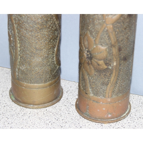 1427 - Pair of WW2 trench art shell vases with Art Nouveau floral design, approx 23cm tall