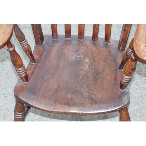 145 - An antique elm seated farmhouse Windsor slatback armchair, approx 60cm W x 47cm D x 116cm H