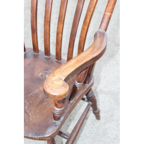 145 - An antique elm seated farmhouse Windsor slatback armchair, approx 60cm W x 47cm D x 116cm H