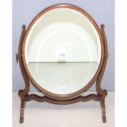 284 - A 19th century mahogany framed oval shaped table top mirror on stand, approx 56cm tall x 45cm wide