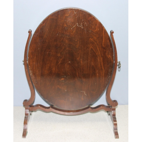 284 - A 19th century mahogany framed oval shaped table top mirror on stand, approx 56cm tall x 45cm wide