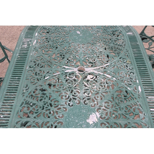 309 - A Victorian style green painted aluminium garden table and chairs, the table approx 138cm W x 80cm D... 