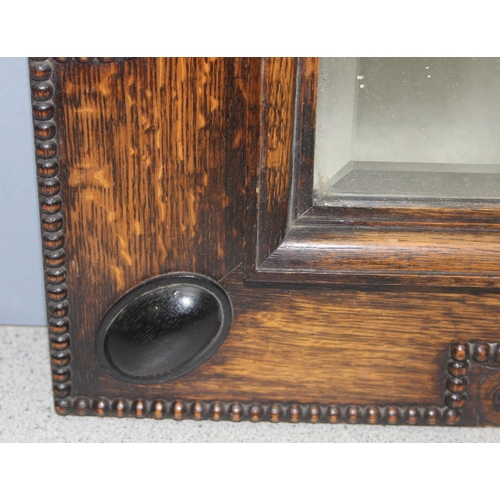 432 - 1920’s rectangular dark oak carved frieze bevelled glass wall mirror, approx 68cm x 58cm