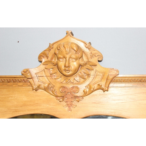 435 - Large Victorian satinwood wall hanging mirror with well carved cherub head pediment, approx 85cm x 7... 