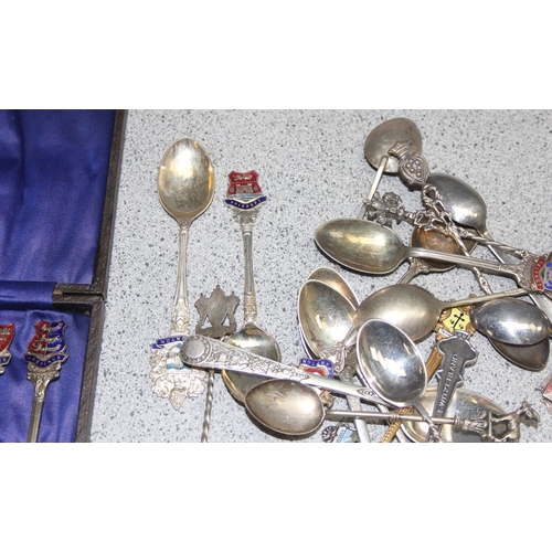 1052 - Qty of assorted silver plated collectors spoons, some with enamel decoration