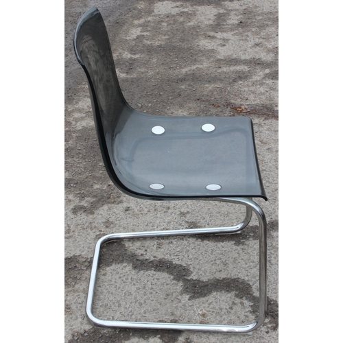 163 - A pair of retro charcoal Perspex and chrome cantilever chairs, seemingly unmarked