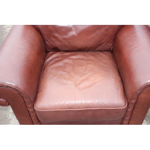 164 - An antique style rolled arm club or armchair with brown leather upholstery by Decro Industrial LTD c... 