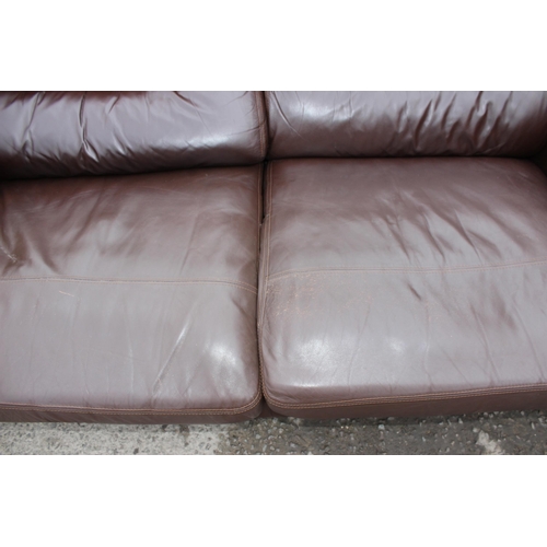 165 - A good quality modern dark brown leather 2 seater sofa, one of 2 matching in the sale with labels fo... 