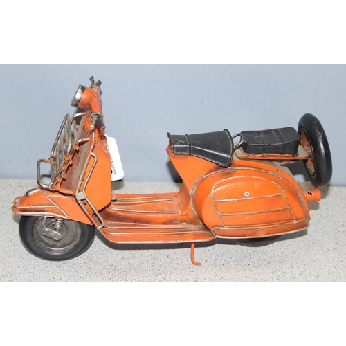 1759 - Ornamental painted tinplate scooter model in orange, believed to be a Lambretta, approx 30cm long