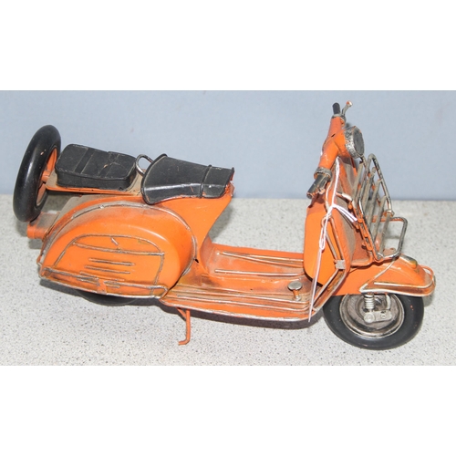 1759 - Ornamental painted tinplate scooter model in orange, believed to be a Lambretta, approx 30cm long