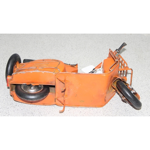 1759 - Ornamental painted tinplate scooter model in orange, believed to be a Lambretta, approx 30cm long