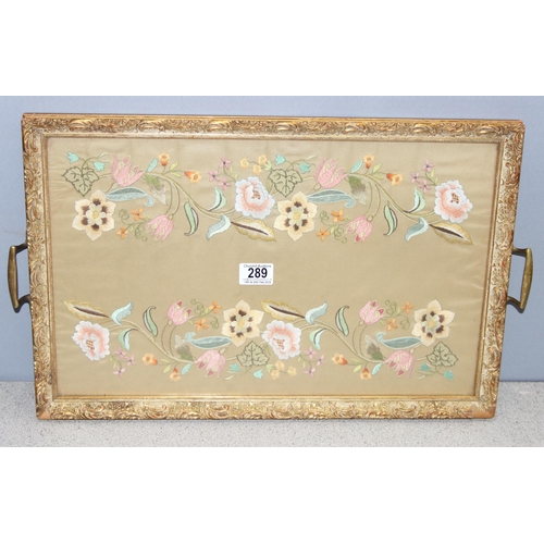 289 - Serving tray comprised of a glazed embroidery with gilt-frame edging, approx 55 x 35cm