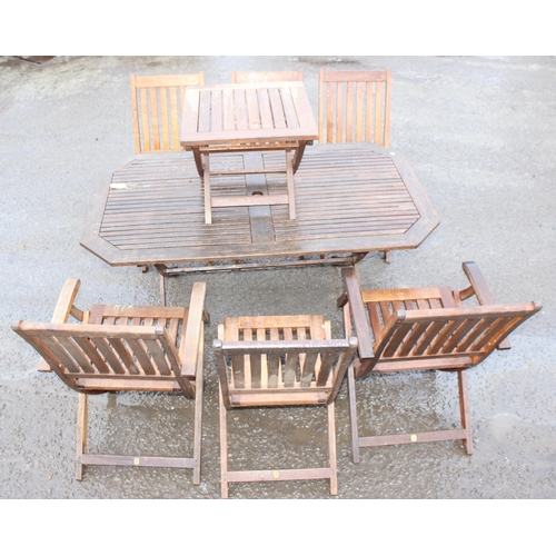 328 - A teak garden table with 6 folding chairs and a smaller folding side table, the table approx 150cm w... 