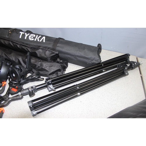 664 - Tycka studio photography lighting equipment in carry case with tripods, backdrops, bulbs etc