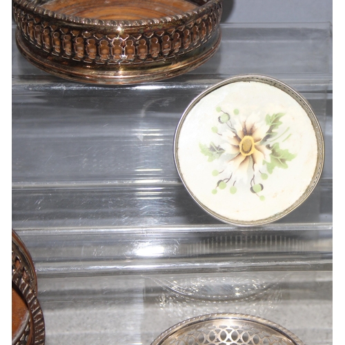 1087 - Assorted antique and later silver-plated items, mostly wine coasters chambersticks