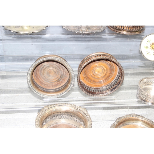 1087 - Assorted antique and later silver-plated items, mostly wine coasters chambersticks