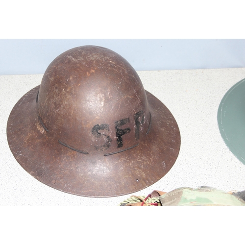 1466 - 2 x WW2 period British military Zuckerman helmets and a qty of camouflage and webbing etc