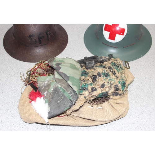 1466 - 2 x WW2 period British military Zuckerman helmets and a qty of camouflage and webbing etc