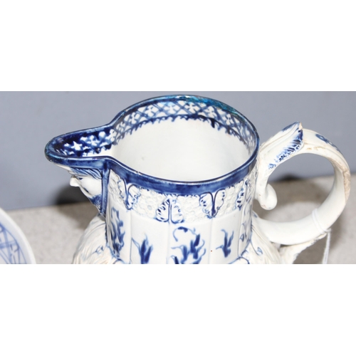 1693 - An antique blue and white pearlware jug with moulded leaf design and bacchanalian spout, approx 18cm... 