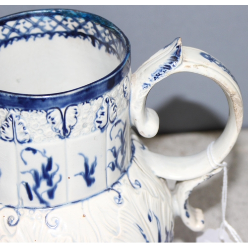 1693 - An antique blue and white pearlware jug with moulded leaf design and bacchanalian spout, approx 18cm... 