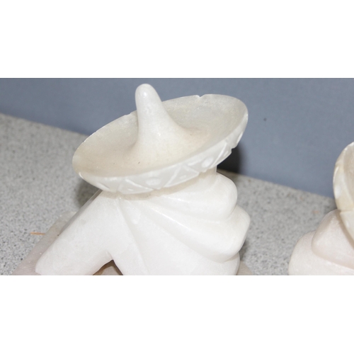 1780 - Pair of carved alabaster bookends of resting Mexican men with sombrero, approx 16cm tall