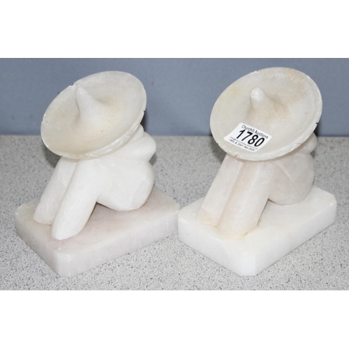 1780 - Pair of carved alabaster bookends of resting Mexican men with sombrero, approx 16cm tall