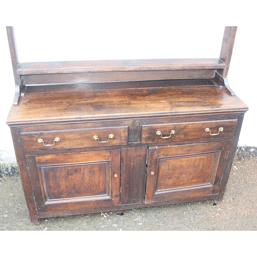 192 - An antique country oak dresser with plate rack, likely early 19th century, the base formed with 2 dr... 