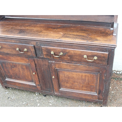 192 - An antique country oak dresser with plate rack, likely early 19th century, the base formed with 2 dr... 