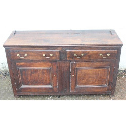 192 - An antique country oak dresser with plate rack, likely early 19th century, the base formed with 2 dr... 