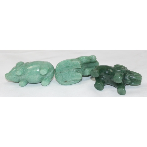 1604 - 3 small carved green hardstone animals, possibly Jade, Elephant, Pig and Cat, the largest approx 60m... 