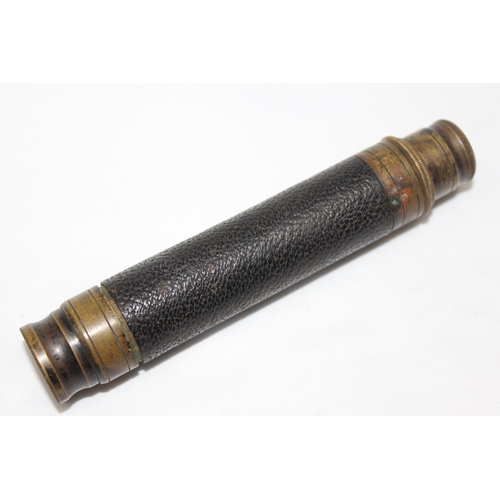 655 - A small vintage brass and leather 2 drawer telescope and a small wooden spirit level (2)