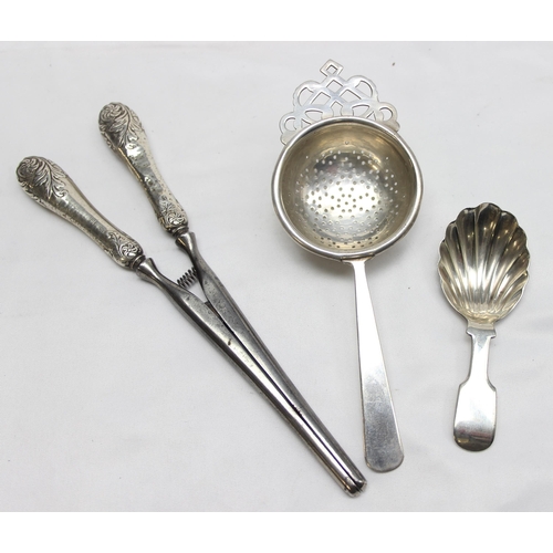 1017 - A pair of silver handled glove stretchers, a silver plated caddy spoon, silver plated tea strainer a... 