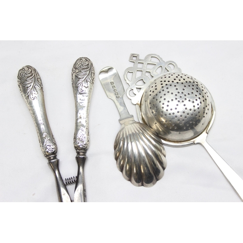 1017 - A pair of silver handled glove stretchers, a silver plated caddy spoon, silver plated tea strainer a... 