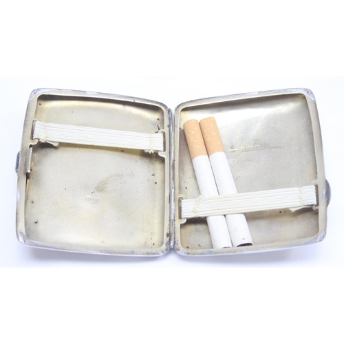 1037 - A vintage plain silver cigarette case, containing 2 cigarettes, Birmingham 1945, makers mark indisti... 