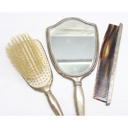 1042 - Birks of Canada, a silver mounted 3 piece dressing table set comprising of a hand mirror, a brush an... 