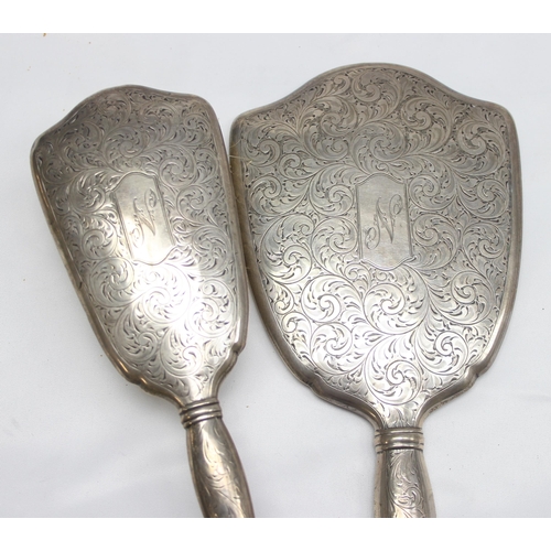 1042 - Birks of Canada, a silver mounted 3 piece dressing table set comprising of a hand mirror, a brush an... 