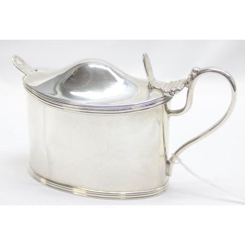 1063 - A large and impressive Victorian solid silver mustard pot with engraved armorial crest and blue glas... 