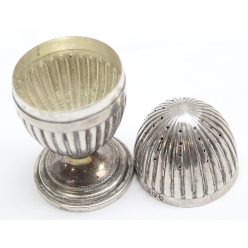 1070 - A decorative Victorian silver pepper pot of gadrooned egg shape, London 1895 by Horace Woodward & Co... 