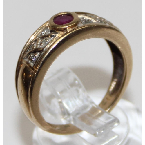 1121 - 9ct gold retro style ruby and diamond ring, a round central ruby flanked by small diamonds, marked a... 