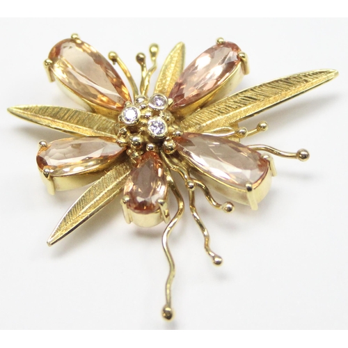 1143 - A vintage 18ct gold pendant formed as a flower, the piece formed with textured gold, citrines and th... 