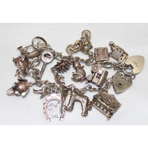 1158 - A vintage silver charm bracelet and a large qty of charms, approx 61.05g gross