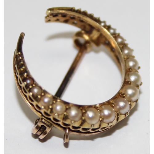 1166 - A 14ct gold and seed pearl set crescent shaped brooch, seemingly unmarked but XRF tests as 14ct gold... 