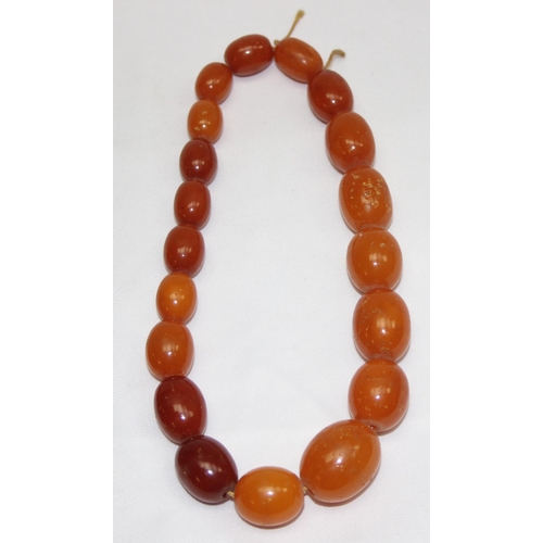 1169 - A vintage bead necklace, possibly Amber, the largest bead approx 24mm wide and a further bracelet wi... 