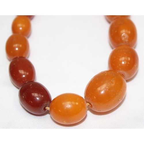 1169 - A vintage bead necklace, possibly Amber, the largest bead approx 24mm wide and a further bracelet wi... 