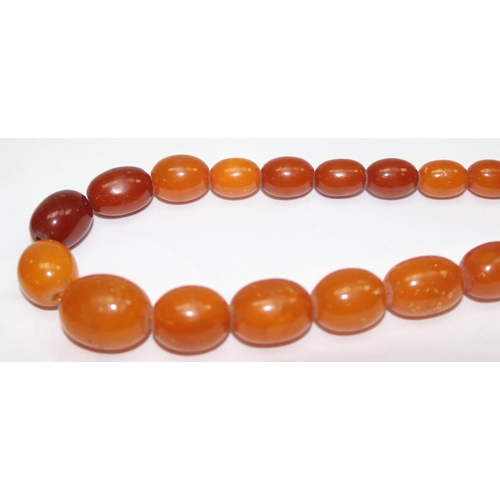 1169 - A vintage bead necklace, possibly Amber, the largest bead approx 24mm wide and a further bracelet wi... 