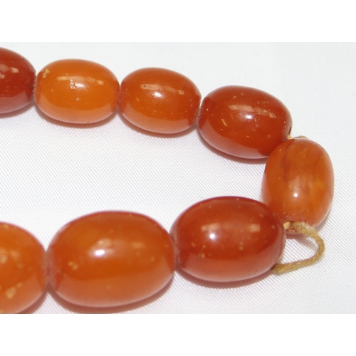 1169 - A vintage bead necklace, possibly Amber, the largest bead approx 24mm wide and a further bracelet wi... 