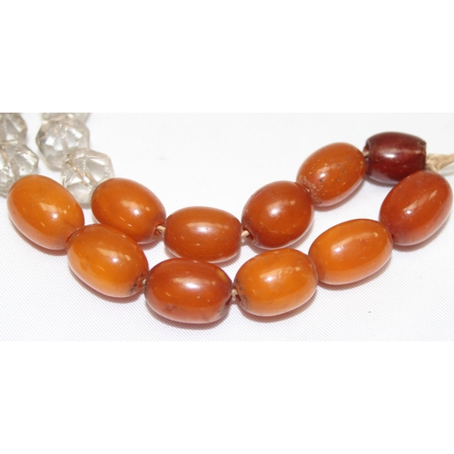 1169 - A vintage bead necklace, possibly Amber, the largest bead approx 24mm wide and a further bracelet wi... 